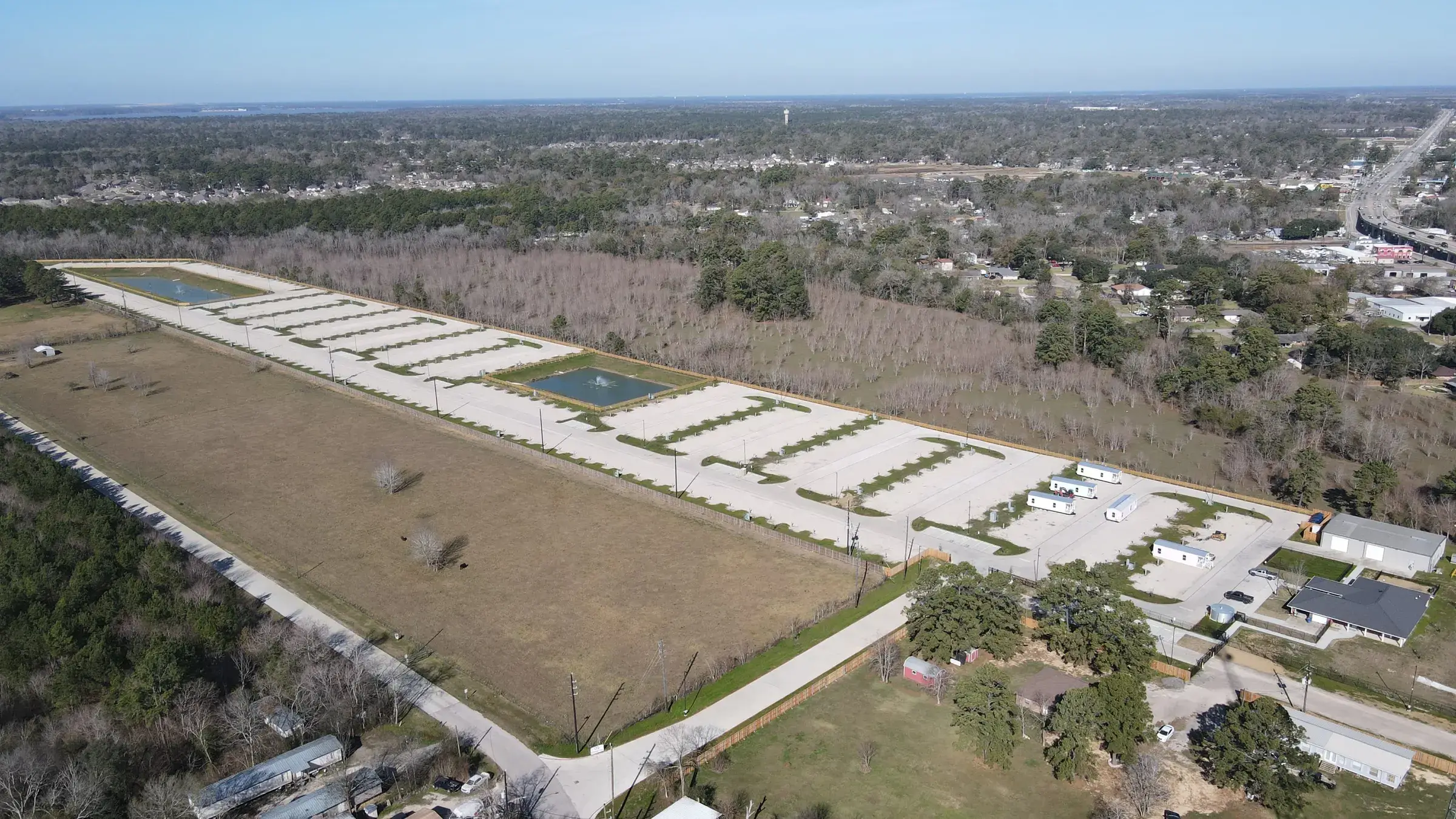 Aerial view of the Gated Rentals Crosby development — paved drives and finished pads laid out across the cleared site
