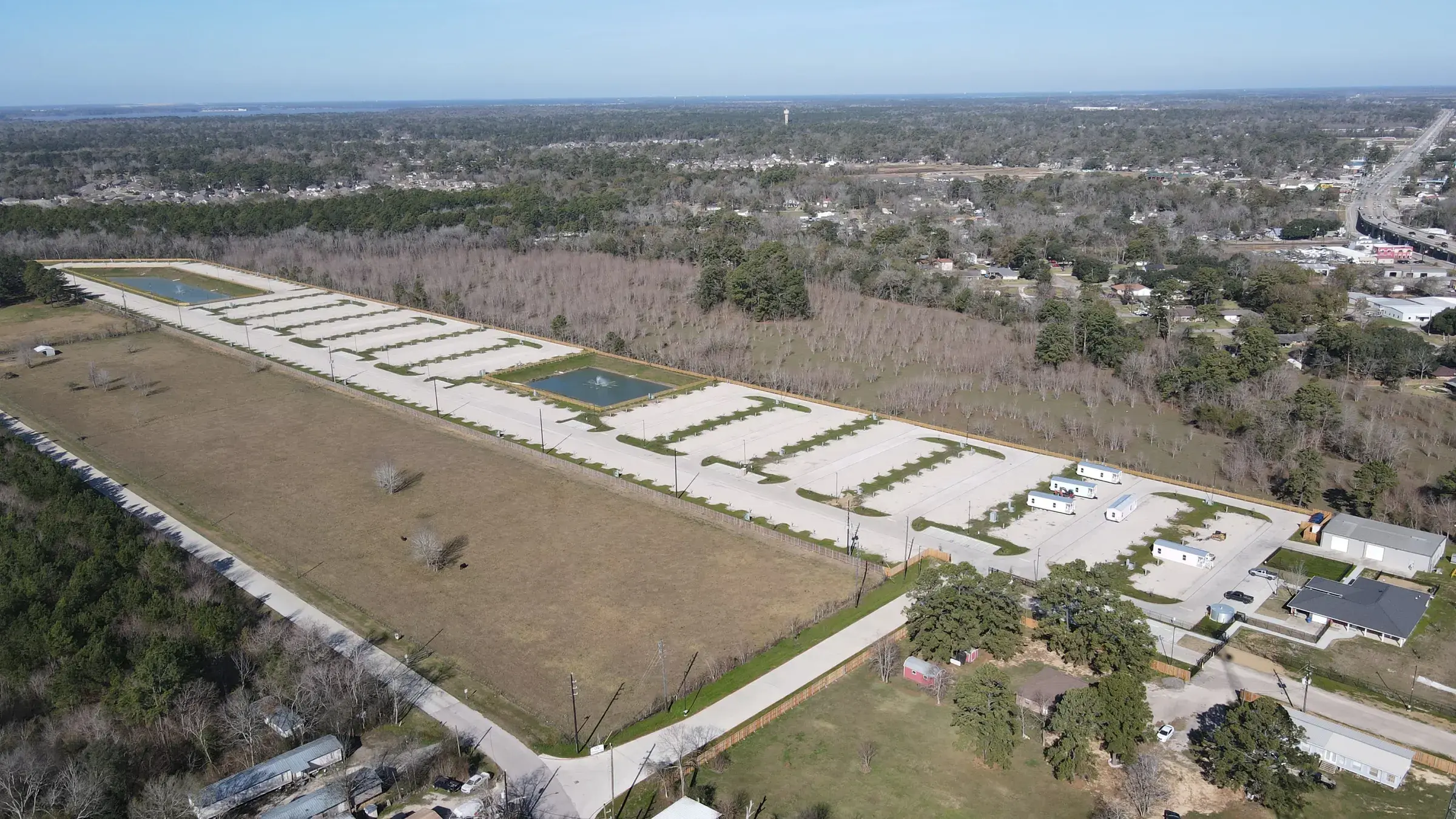 Aerial view of the Gated Rentals Crosby development — paved drives and finished pads laid out across the cleared site