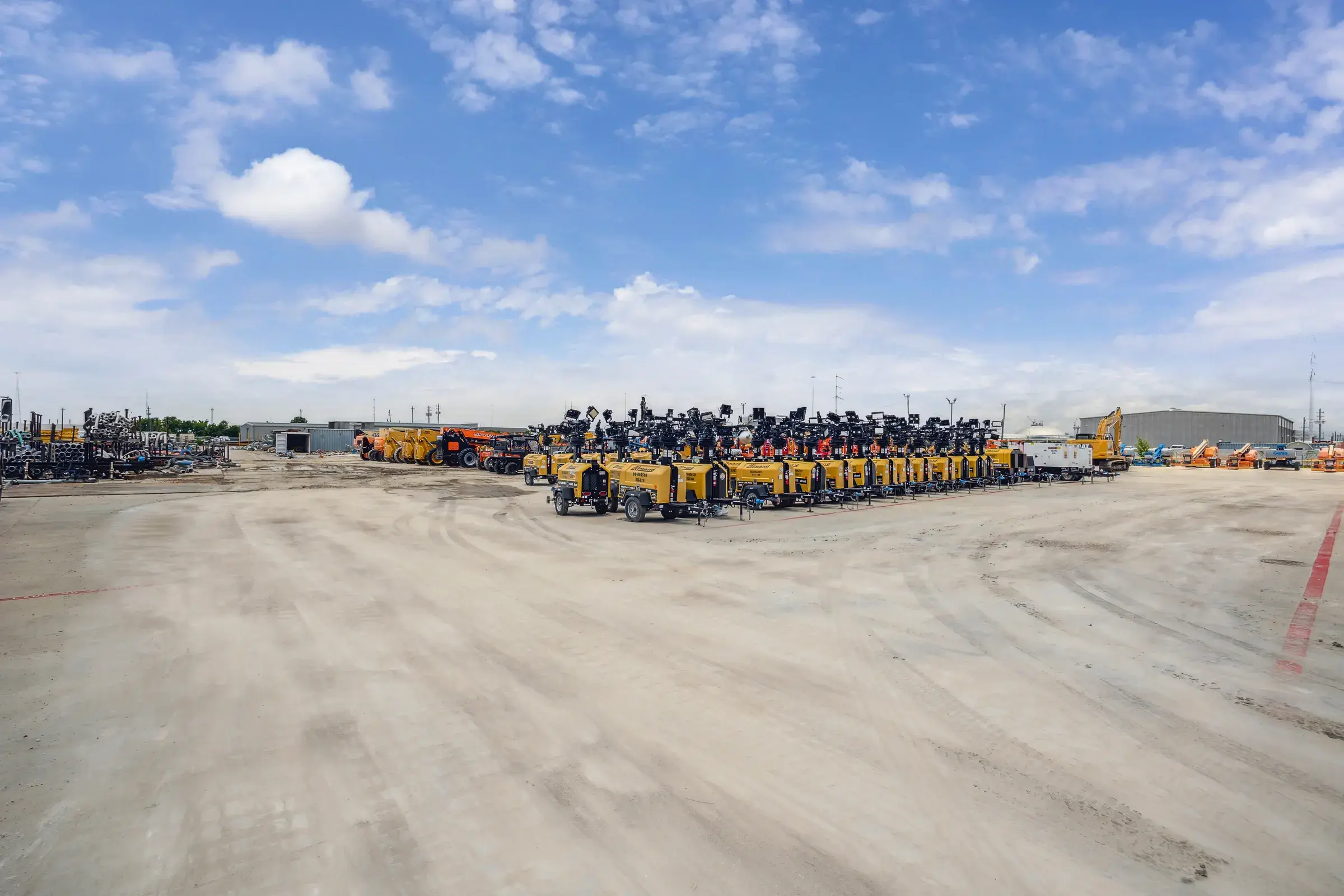 Rows of machines staged across the yard, ready to go out